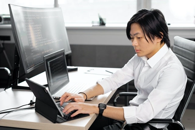 A man using his mini laptop